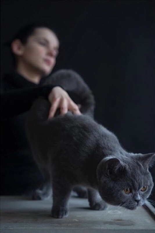 Portrait of HOHLIK with a cat, capturing a mood of darkness and creativity: A striking photograph by Marcel Beranek.